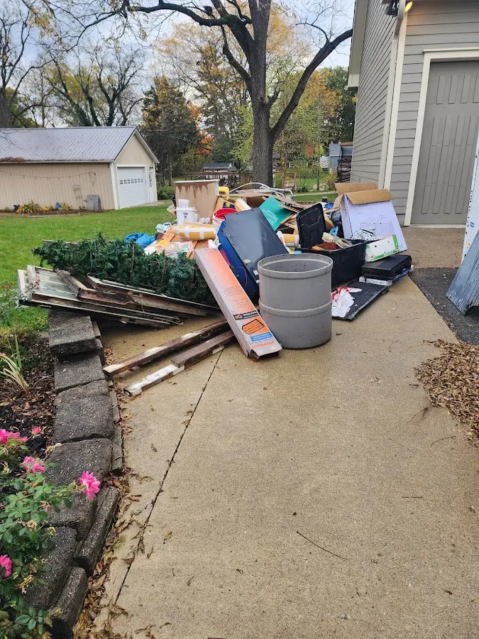 Dumpster being loaded with debris for Estate Cleanout Dumpster Rental in Zimmerman